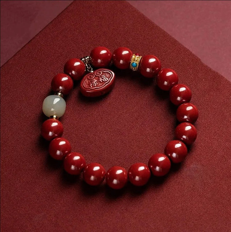 Red cinnabar Emperor Sandstone Ping An Fu Lu adjustable bracelet on wrist.