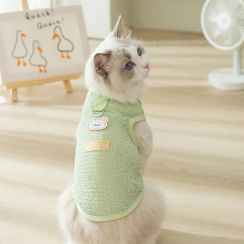 Bear patch cat clothing in hollowed-out knitted fabric shown in blue, green and yellow colours