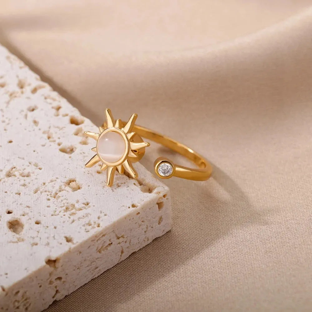 Gold and platinum adjustable geometric decompression spinner rings showing rotatable design