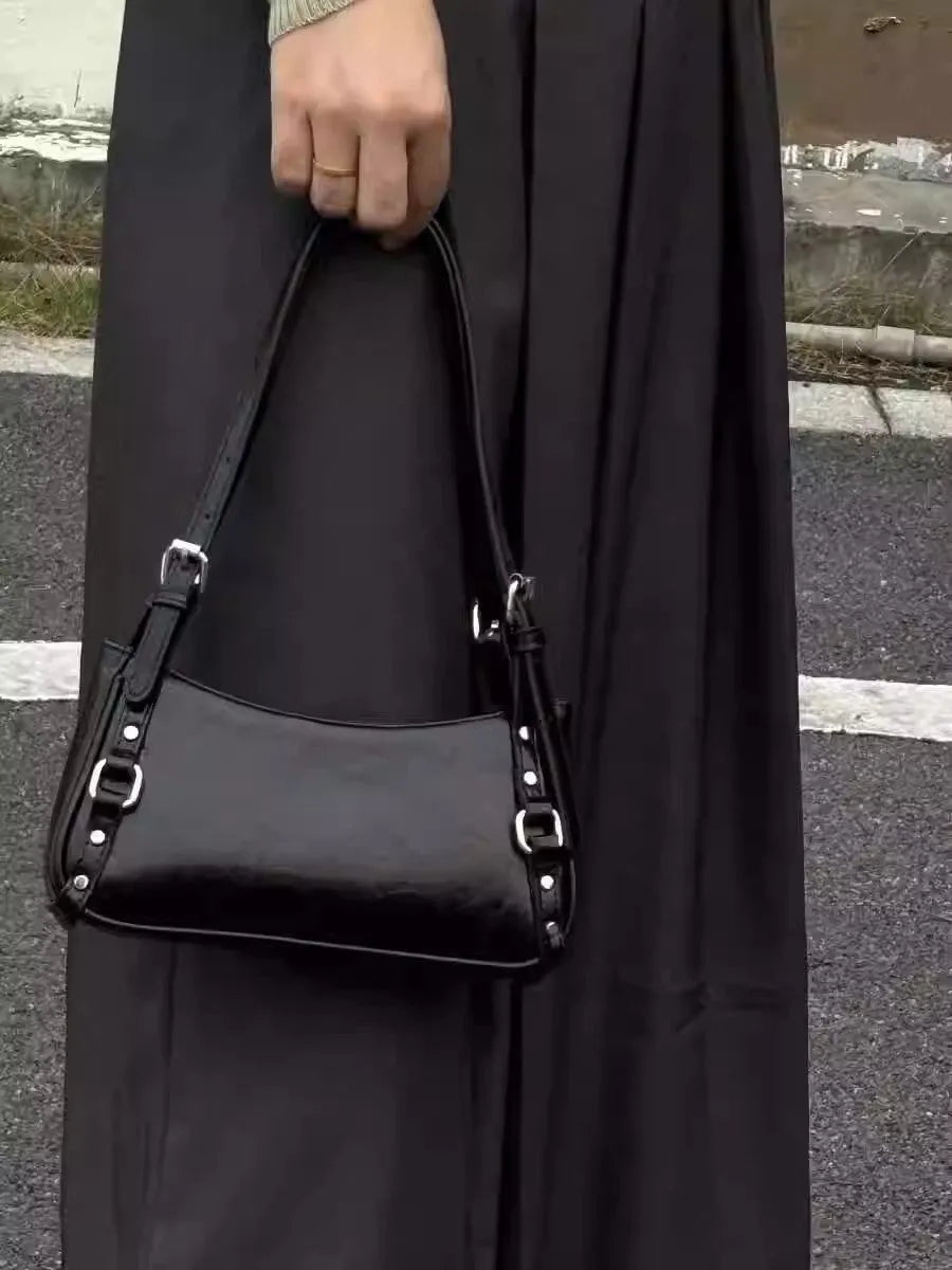 Black PU shoulder bag with horizontal square shape, outer three-dimensional pocket, and internal zipper change bag.