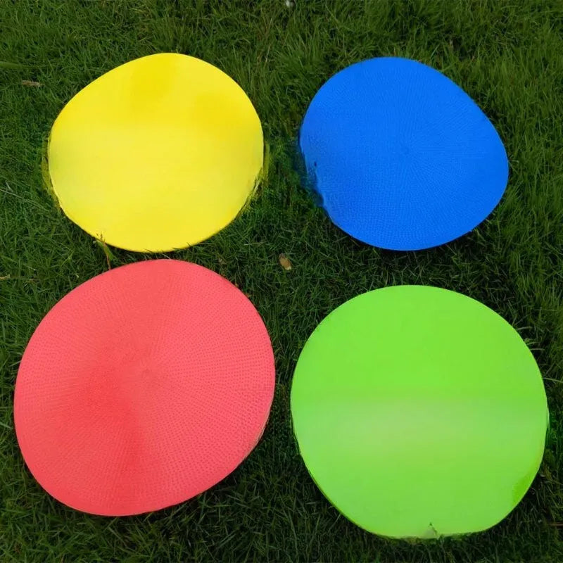 Yellow football training target disc with 23cm diameter on grass pitch