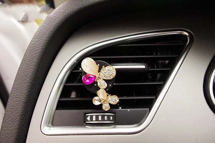 Alloy car perfume clip with liquid fruity scent attached to air vent in various cartoon styles