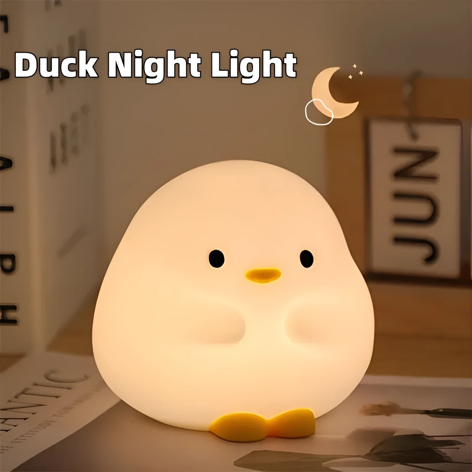 Cute duck shaped LED night lamp with silicone casing and warm light on a bedside table