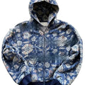 Man wearing a blue loose-fit hooded zip coat with long sleeves and digital printing.