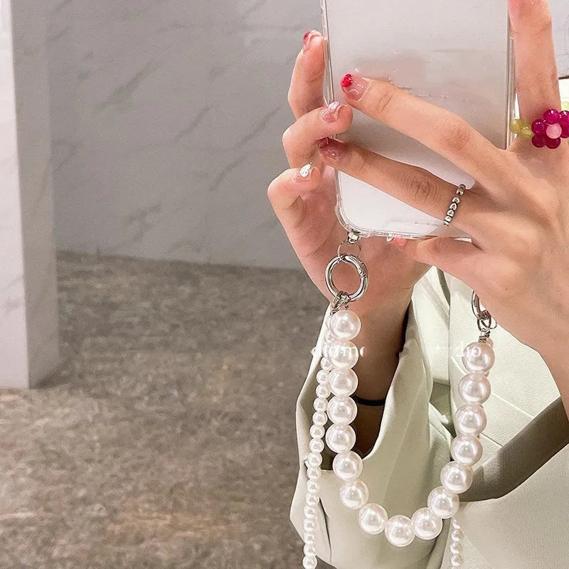 Soft mobile phone case with a white pearl charm chain attached, shown in a selected colour.