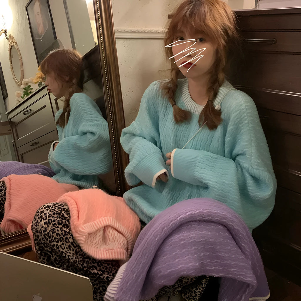 Women's loose blue polyester pullover sweater with regular sleeves on hanger