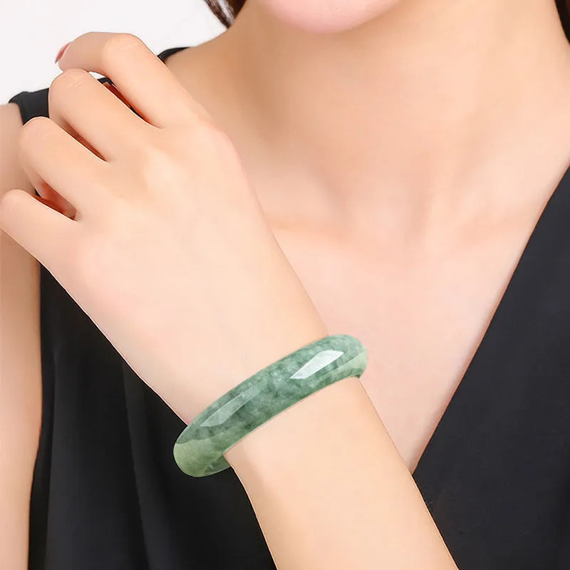 Natural emerald bean green simple solid bracelet on a gift box, showing dark pea green colour.
