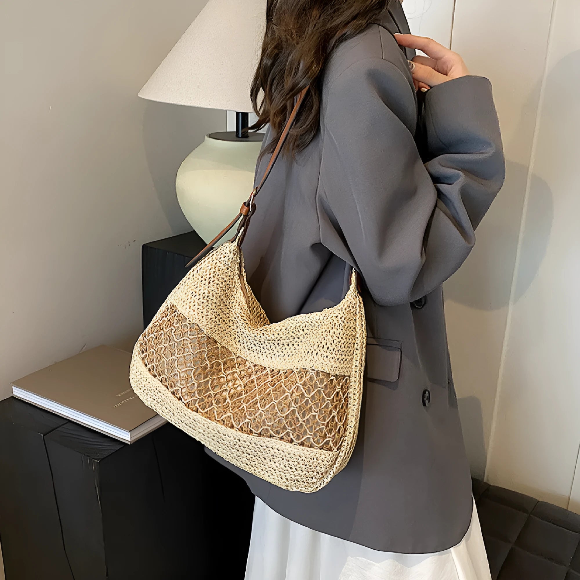 Women's khaki straw cross body bag with a square shape and outer pocket.