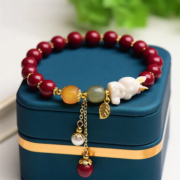 Natural cinnabar rabbit bracelet in national style design showing 8mm and 10mm size options