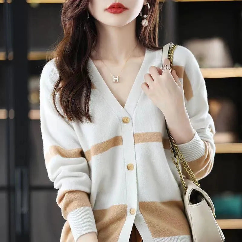 Women's black and white striped knitted cardigan with 3D pattern and V-neck.