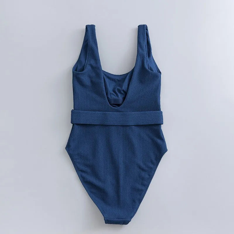 Navy blue women's one-piece swimsuit with triangular chest shape and integrated chest pads