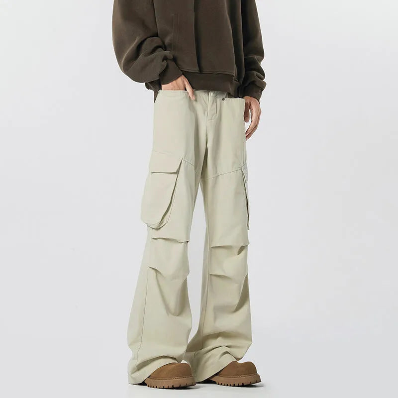 Man wearing black retro high-waist straight-leg casual trousers with a buttoned flap detail.