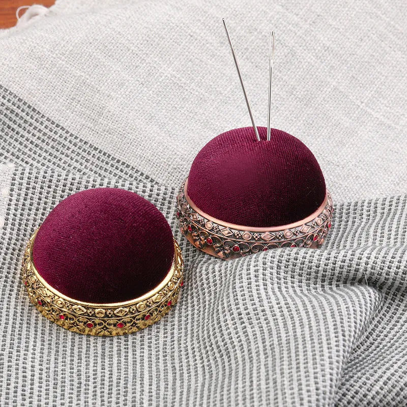 Retro needle ball head pin cushion with velvet cover and alloy insert on sewing table