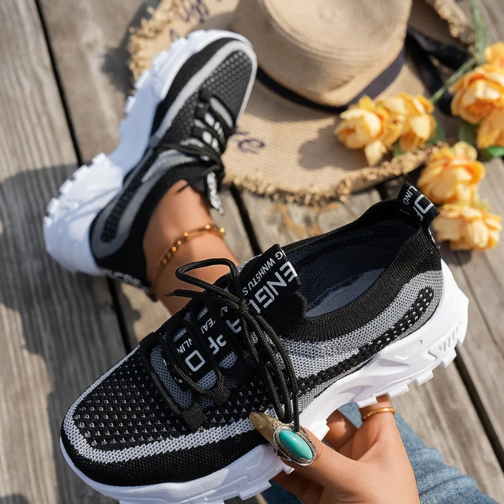 Women's Flyknit mesh lace-up sneakers in low flat heel design for walking and running
