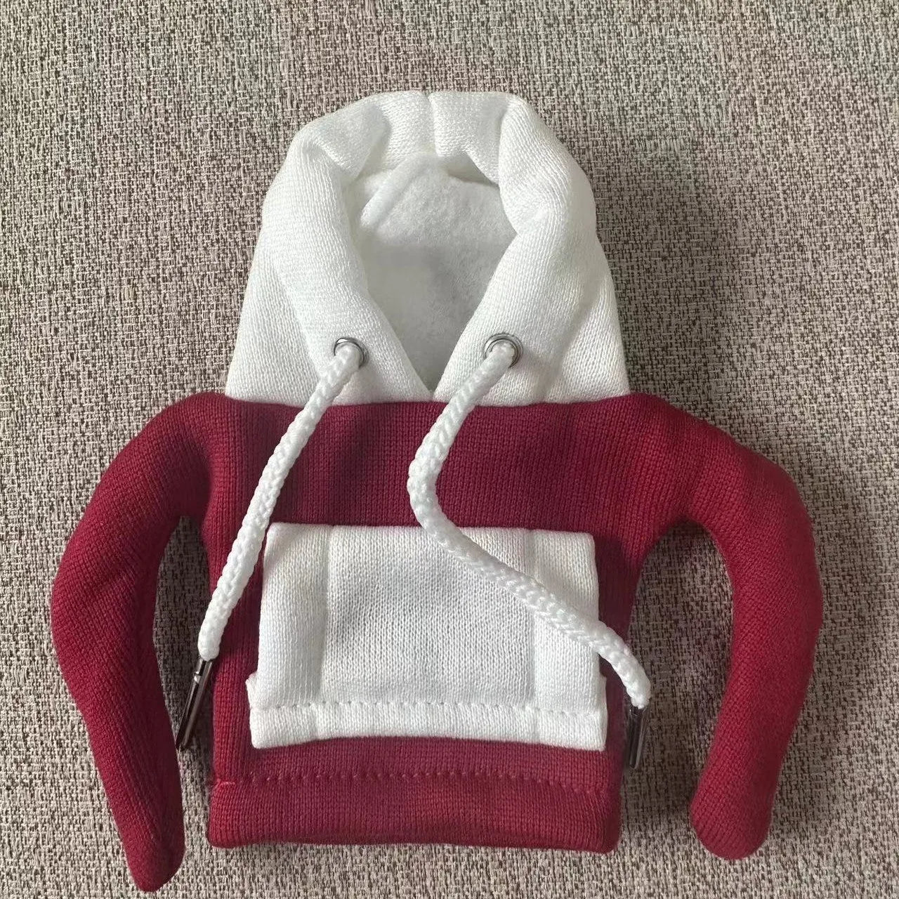 Polyester knit hooded cover stretched over a car manual gear lever in a red and white colour combination.