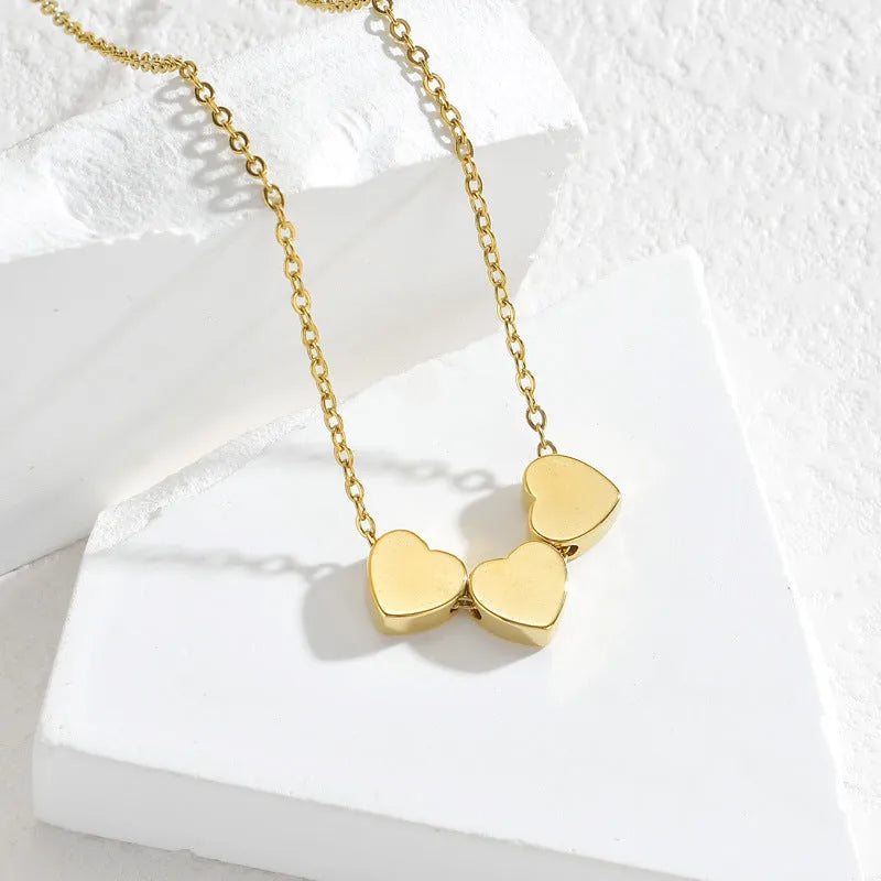 Gold stainless steel three-heart pendant necklace with laser-engraved black text on O-chain