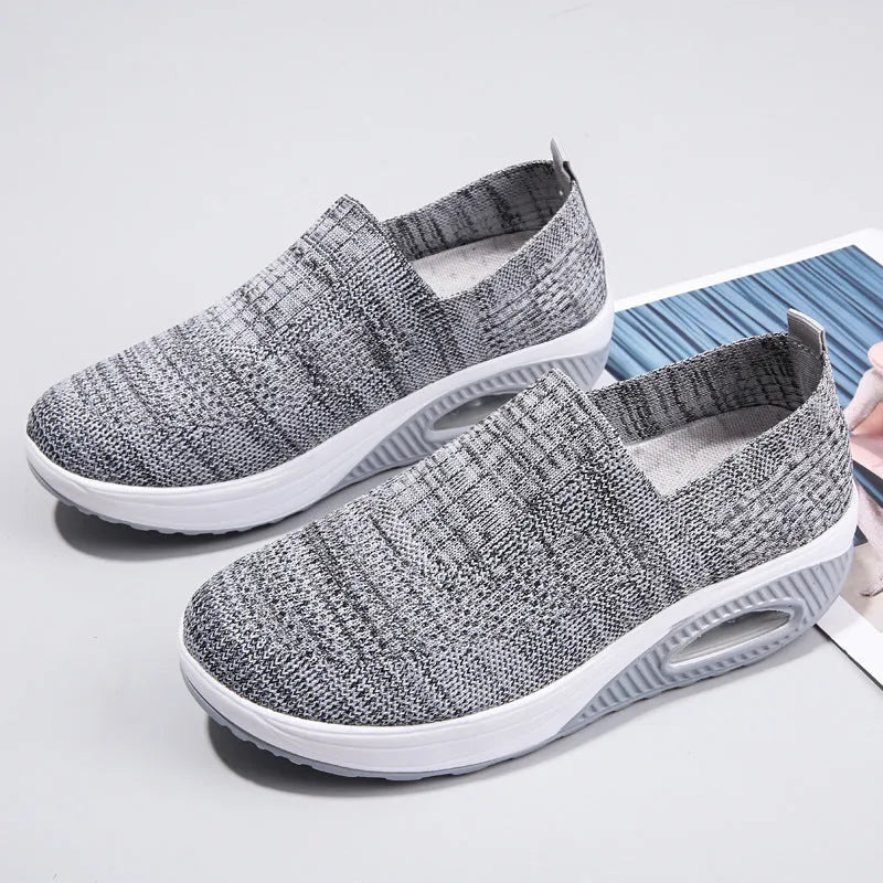 Women's mesh running shoes in beige with round toe and air cushion sole.