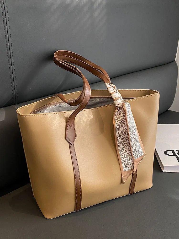 Large capacity tote crossbody bag in bucket style with sandwich pocket design and visible sewing details