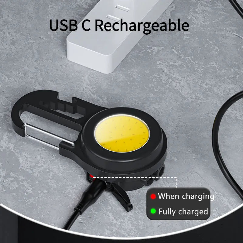 Black 6-in-1 multi-functional mini keychain lamp with COB light and magnetic base on metal surface