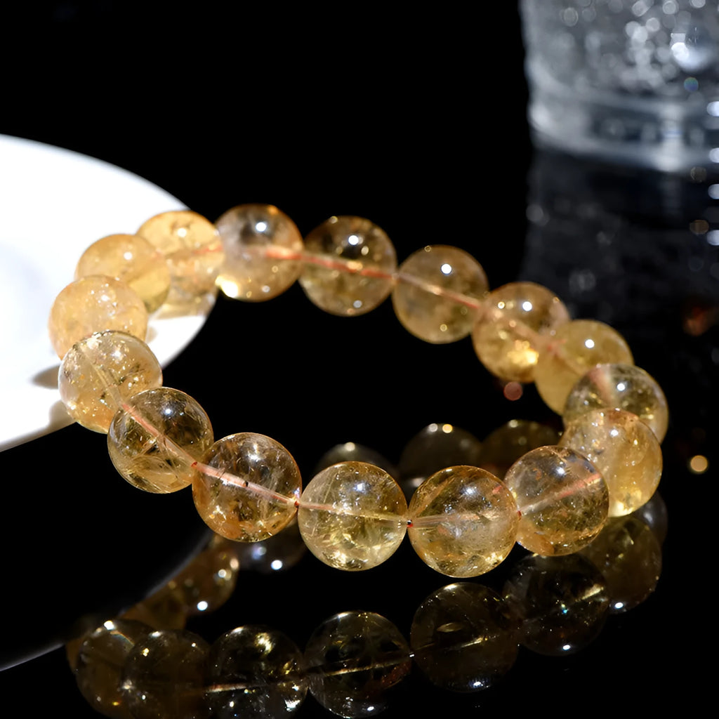 Natural yellow citrine gemstone bracelet with geometric beads on white background