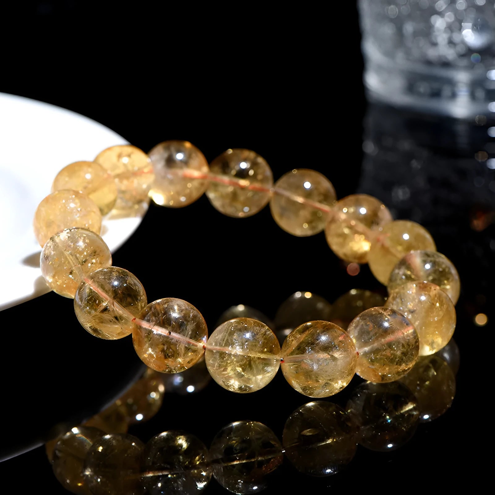 Natural yellow citrine gemstone bracelet with geometric beads on white background