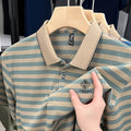A man wearing a red striped short sleeve casual shirt with a mosaic pattern detail.
