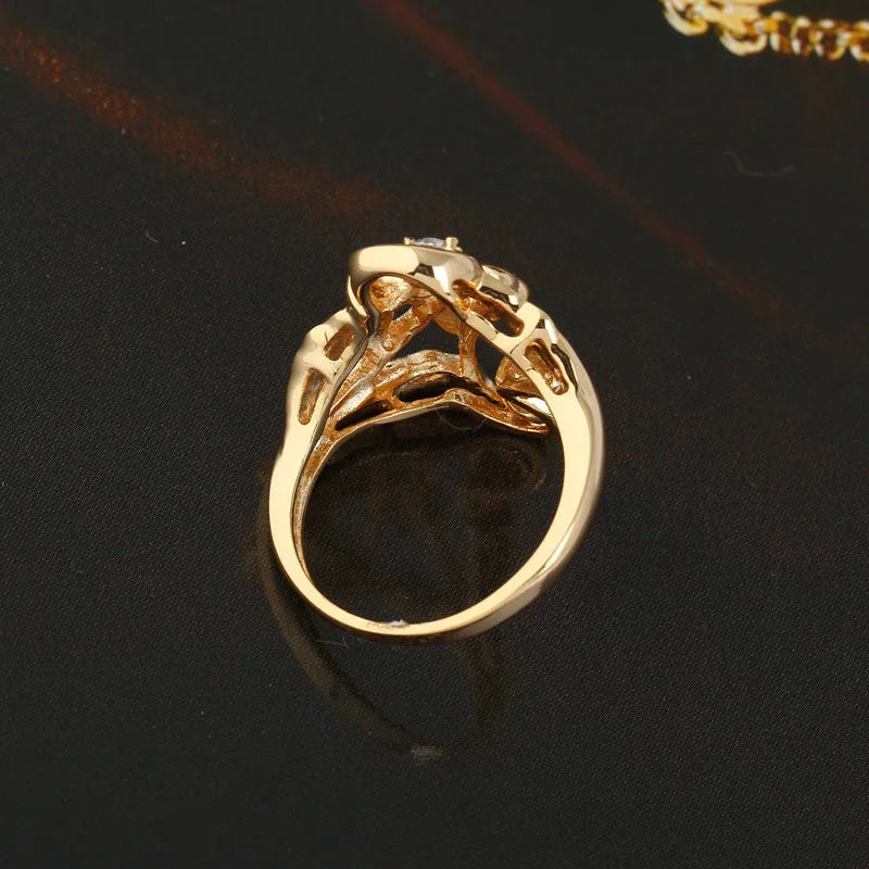 Gold tone copper ring with irregular leaf shape and white zircon crystal on geometric band, women's fashion jewellery