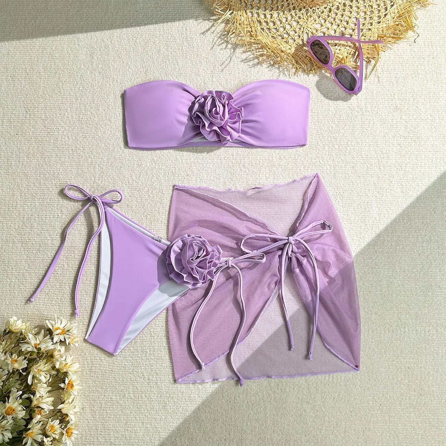 Women's pink swimsuit set with flower tie detail on tube top, matching pants and skirt