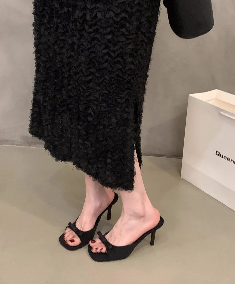Square head fairy bow high heel slippers with ankle strap in beige on display.