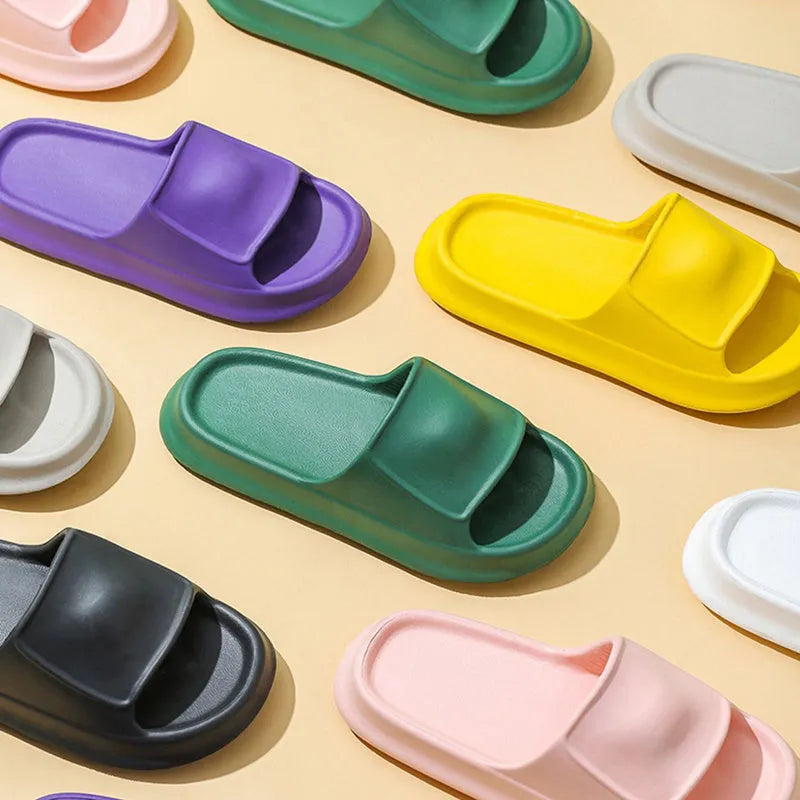 Unisex EVA flip-flop slippers with thick sole, shown in various colours on a bathroom tile floor.