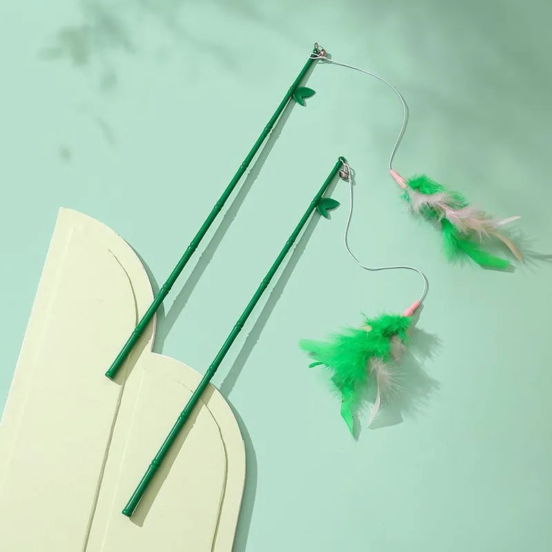 Green interactive cat feather wand toy with bells and feathers for indoor play and training