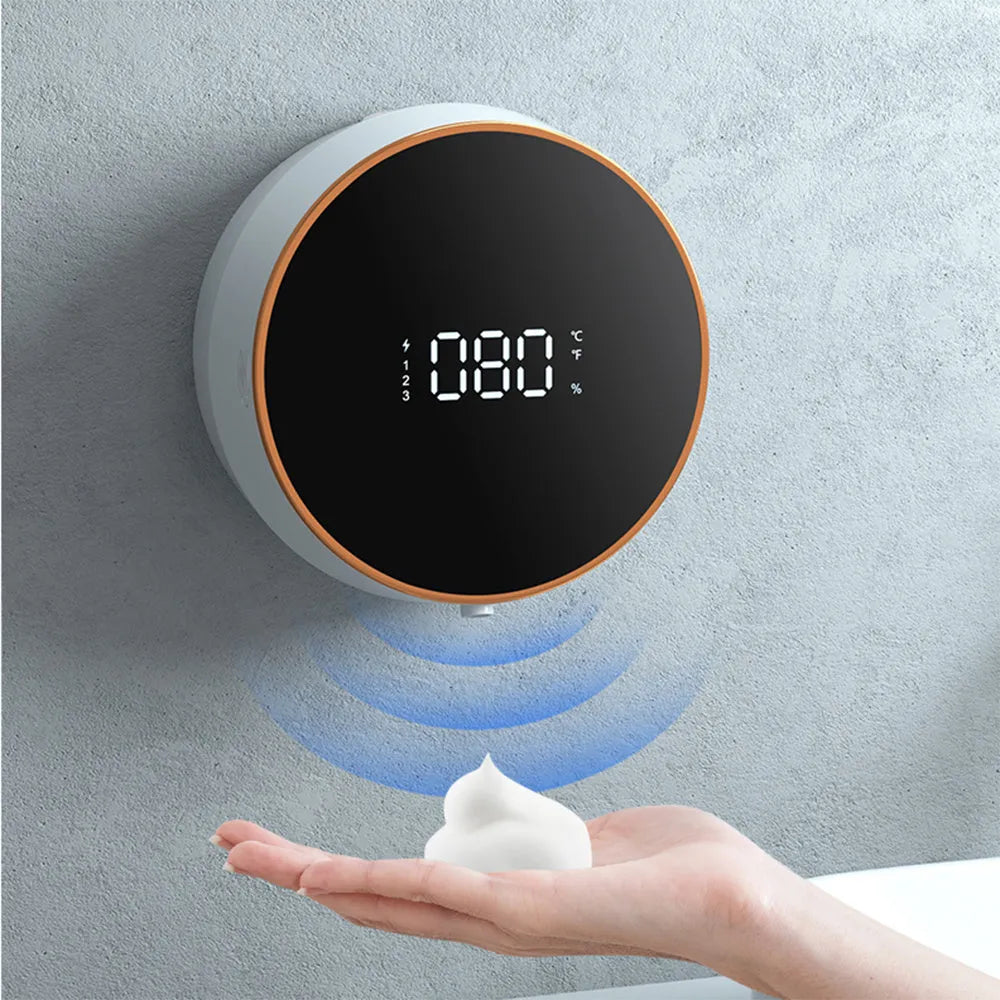 Black automatic foam soap dispenser mounted on wall with USB charging cable