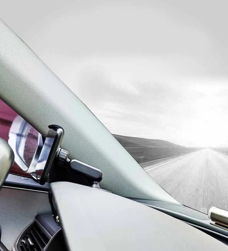 Black multifunctional car phone holder clipped onto a car sun visor, holding a smartphone.