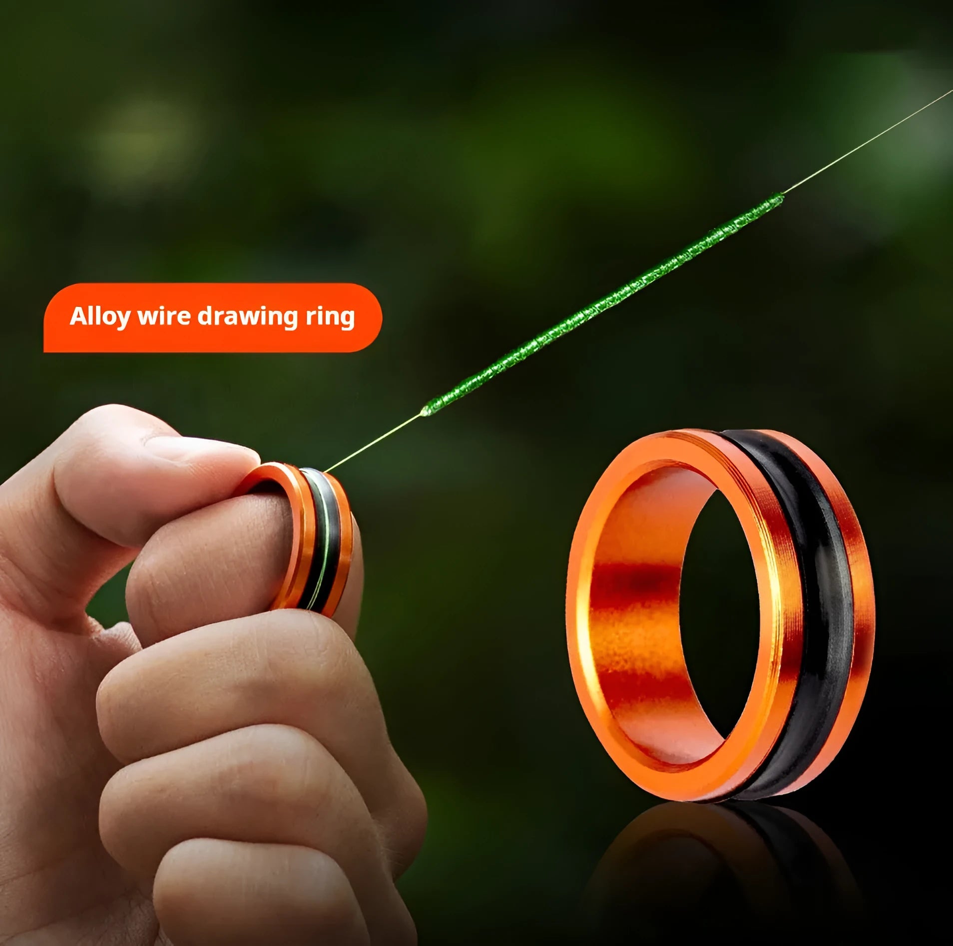 Orange and silver alloy fishing hand guard pull loop tool on a solid background