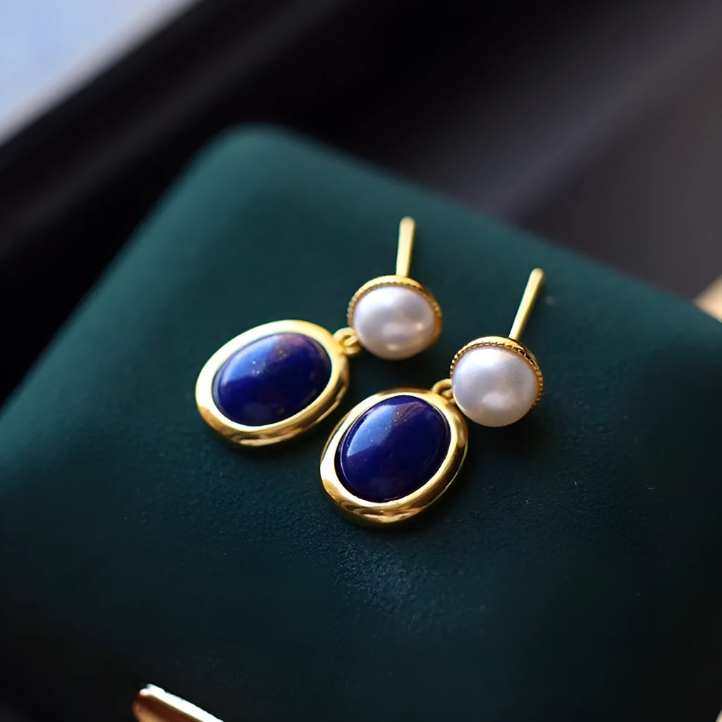 A pair of simple sterling silver stud earrings with a lapis lazuli pearl colour and auspicious patterns.