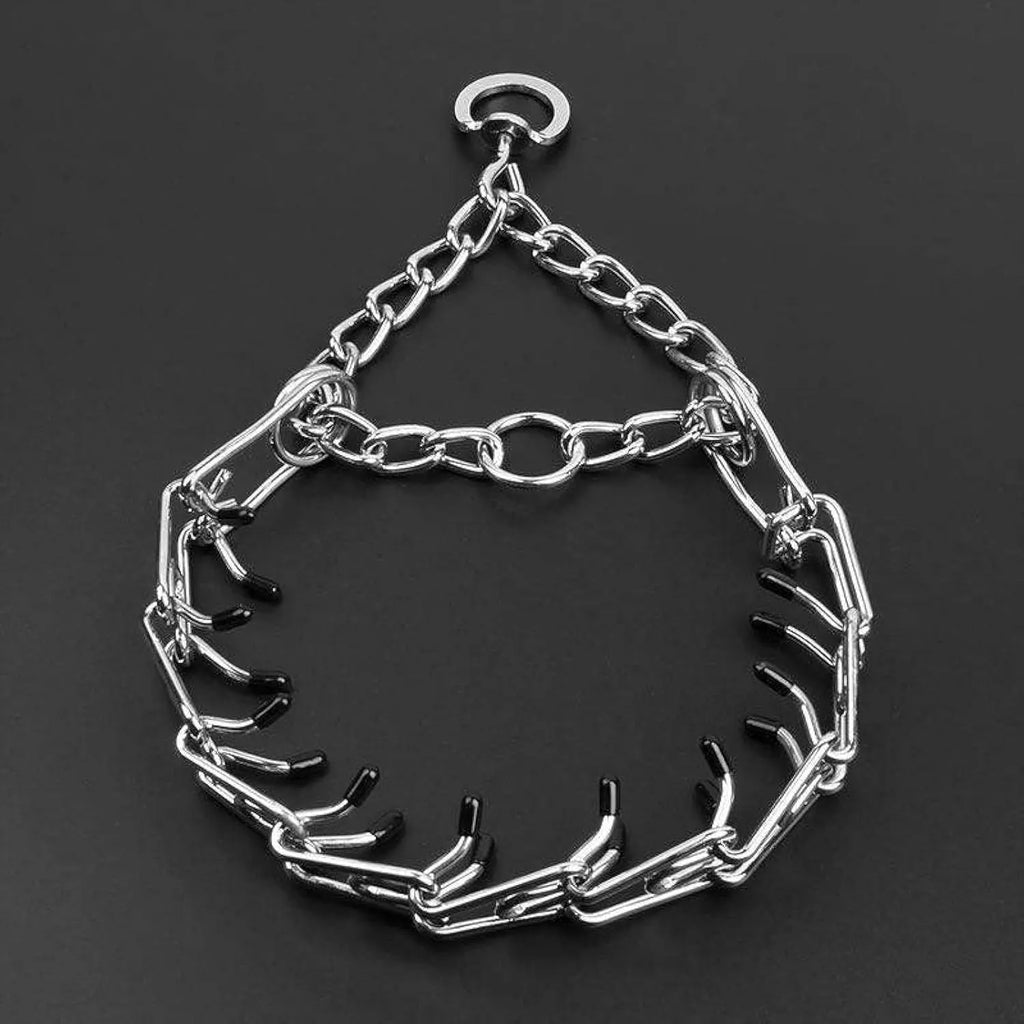 Stainless steel dog prong collar with rubber tips and adjustable chains on a grey background.