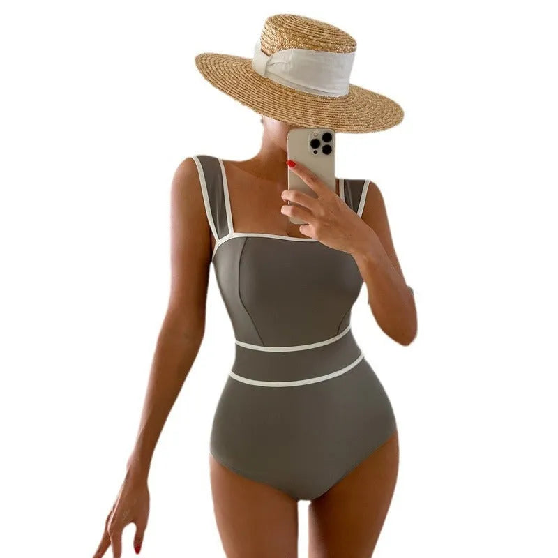 Back view of a women's black one-piece swimsuit with a lace-up back design.
