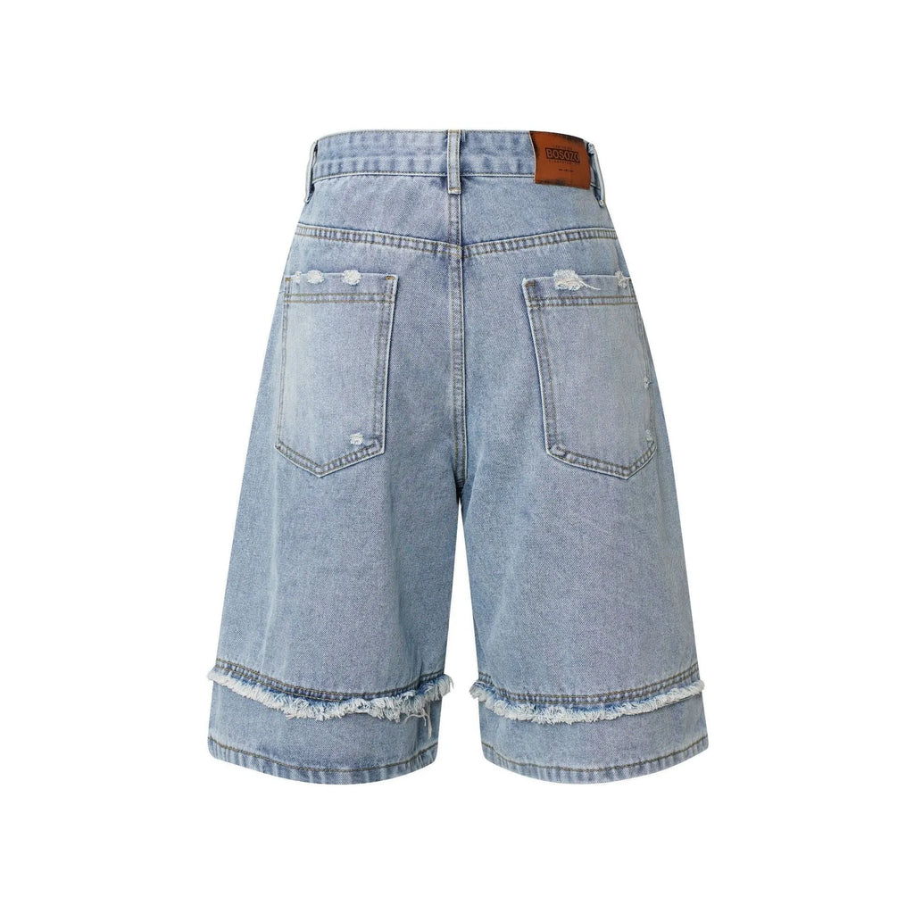 American Pu Shuai distressed raw edge denim shorts in straight leg cropped fit on a grey background.