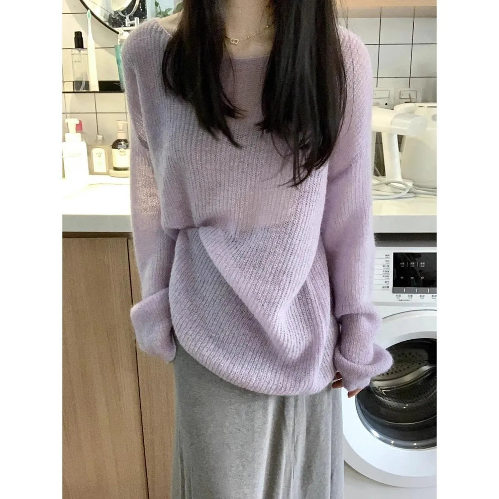 Purple women's round neck blouse with hollow-out detail and princess sleeves on a hanger.