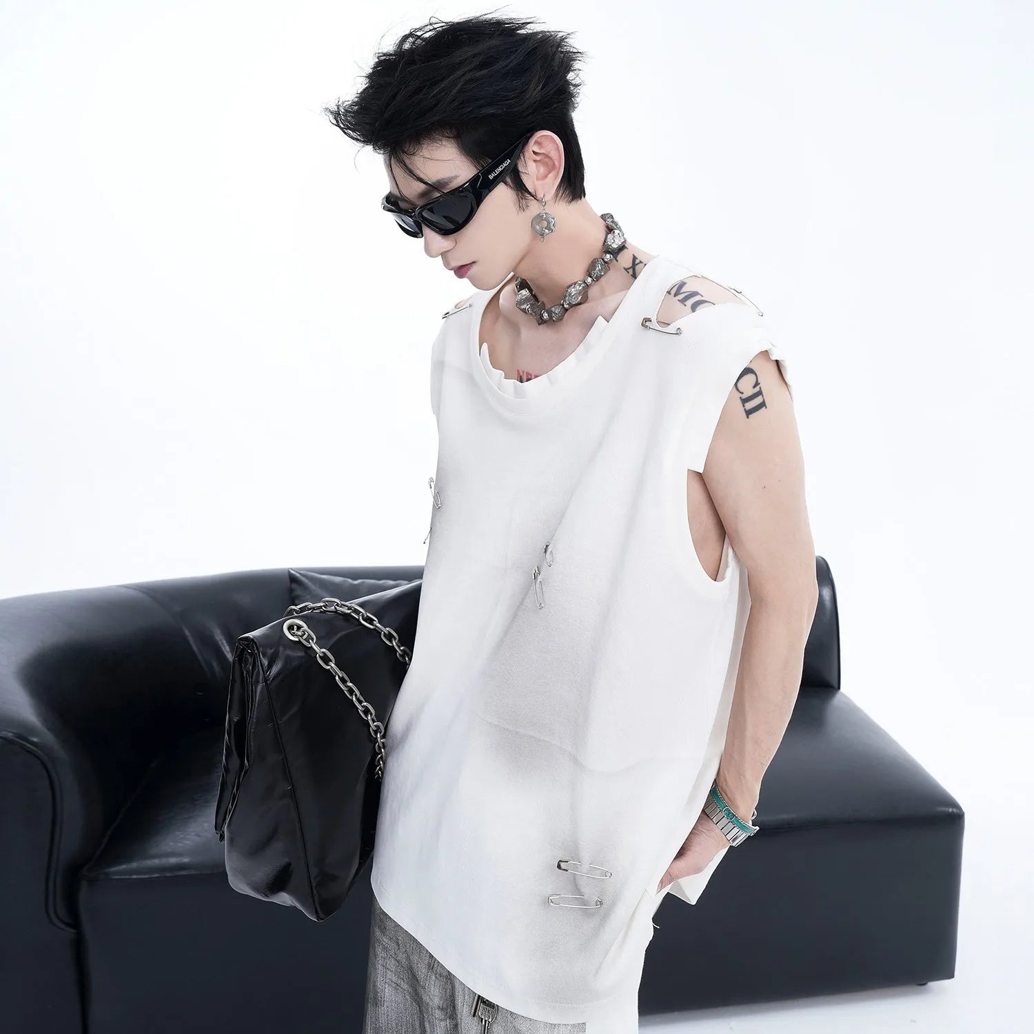 Men's black sleeveless vest waistcoat with irregular ripped cutting detail on a round neck collar.