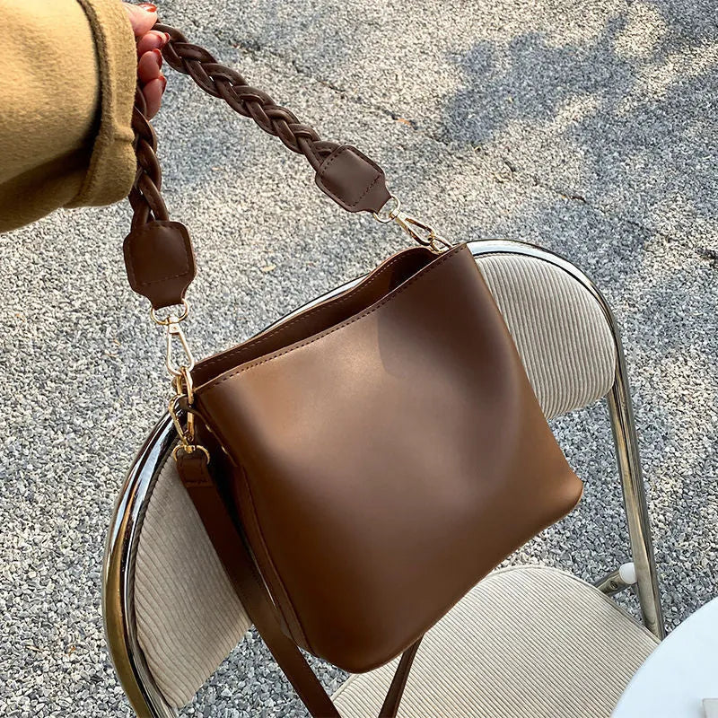 Retro brown PU bucket bag with weaving detail, shown as a one-shoulder crossbody underarm bag.