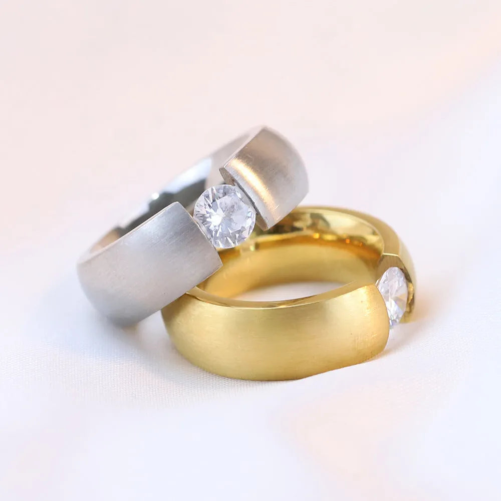 Titanium steel geometric ring with diamond treatment in gold colour finish on white background