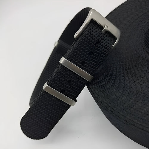 Nylon textile watch strap in army green colour with metal buckle, shown alongside black and blue options.