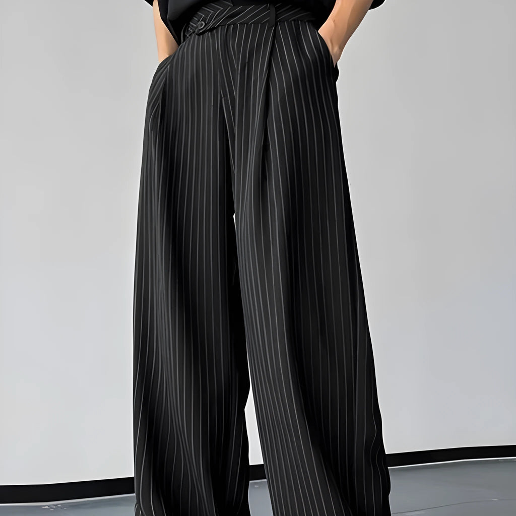Man wearing black vertical striped pleated casual trousers with an elasticated waistband.