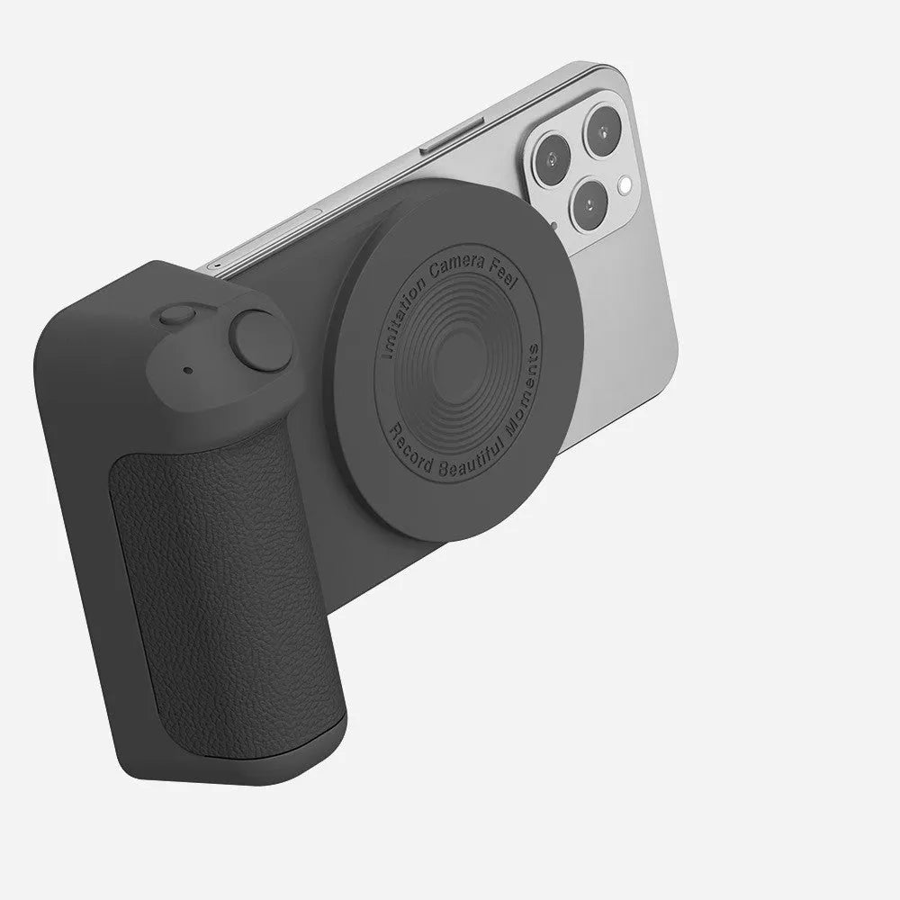 Black magnetic camera handle phone bracket with rotatable grip on wooden table