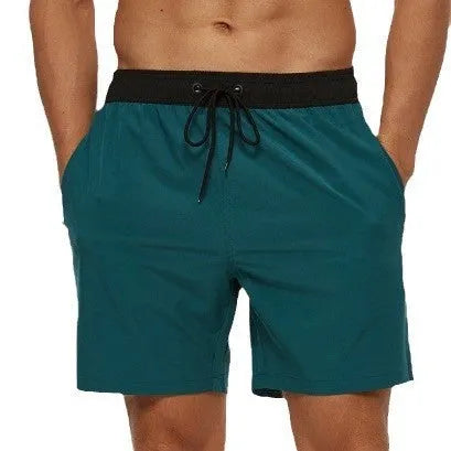 Men's blue athletic shorts with a drawstring waist, zipper pockets, and visible stitching detail.