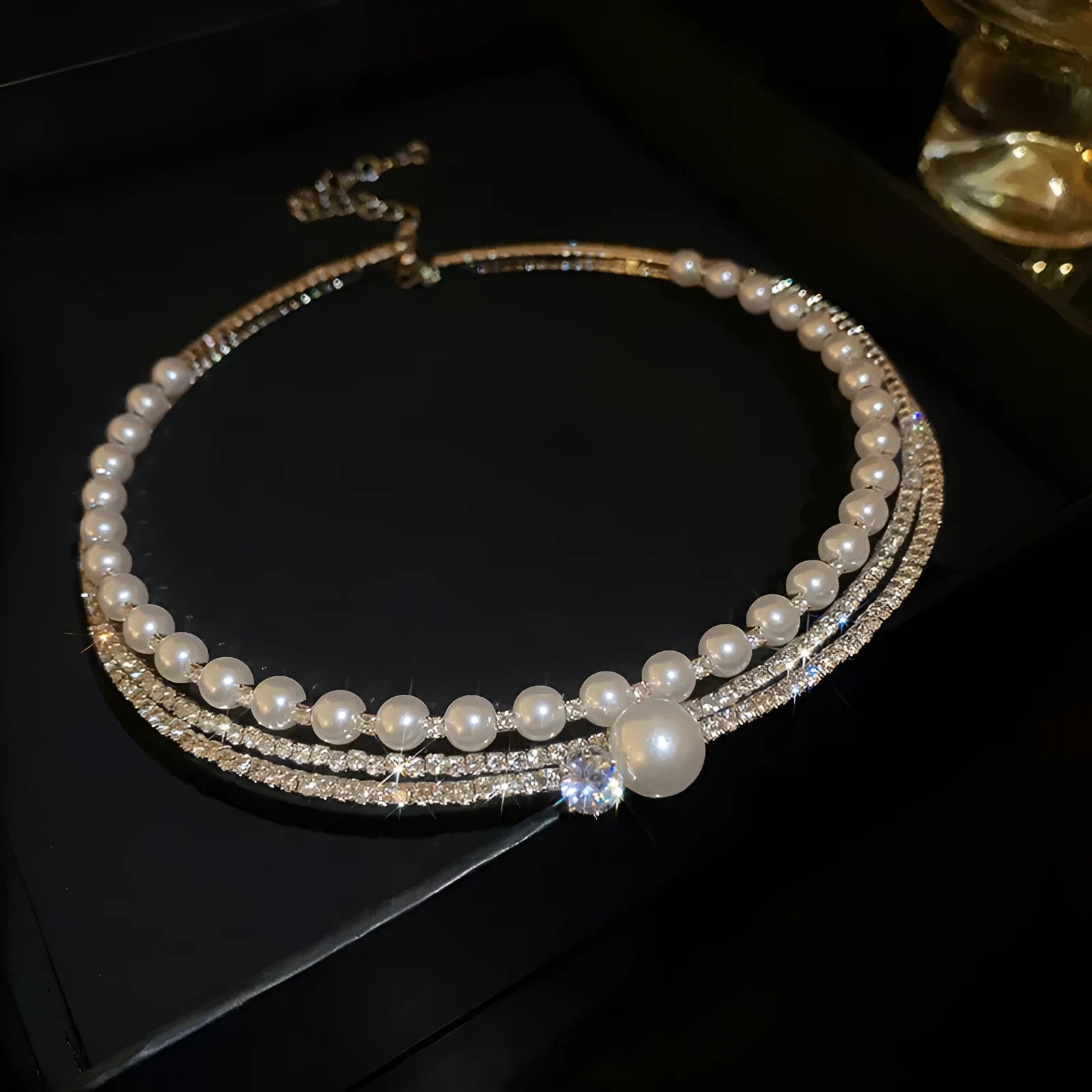 Curved silver geometric women's necklace designed to sit on the collarbone.