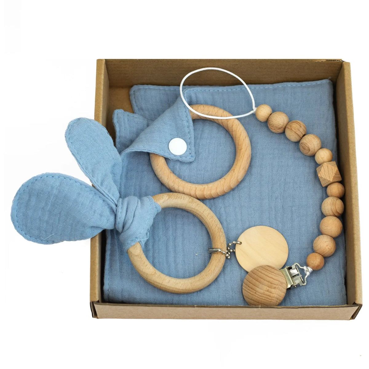 Baby teething toy gift set with bamboo blend gauze blanket, wooden beech bell, teether, brush, and milestone marker.