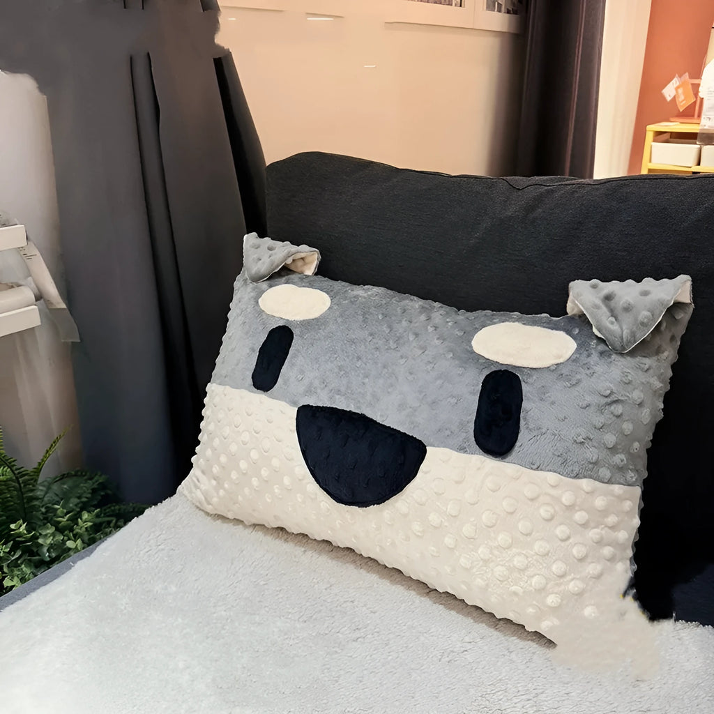 Grey and white West Highland terrier puppy-shaped dog pillow on a sofa.