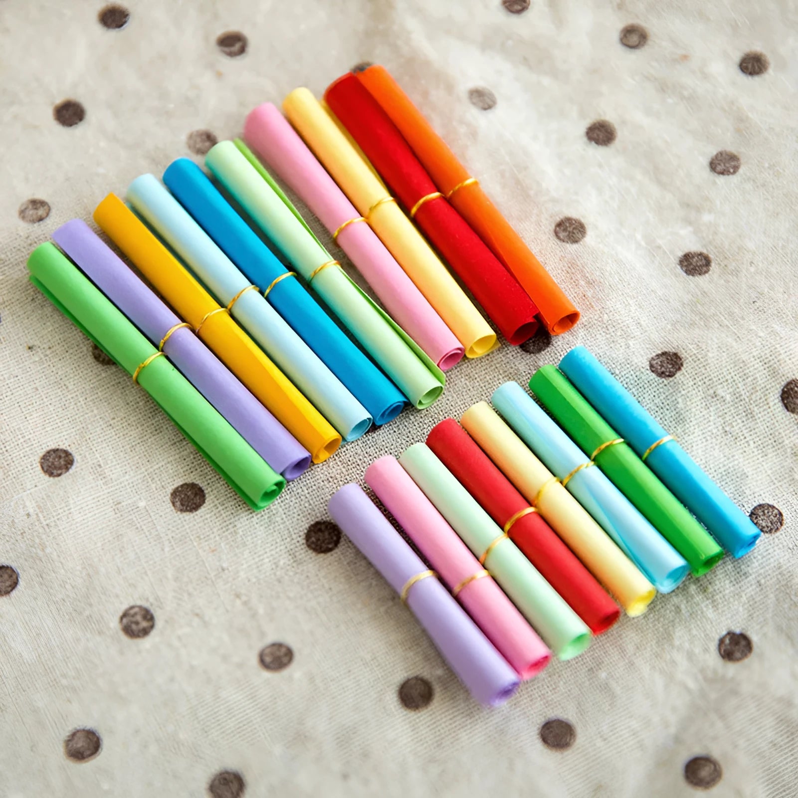 Colourful mini paper scrolls with eyelets in multiple sizes for drift bottle messages
